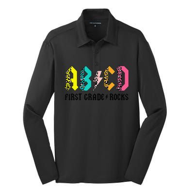 ABCD First Grade Rocks Back To School 1st Grade Teacher Silk Touch Performance Long Sleeve Polo