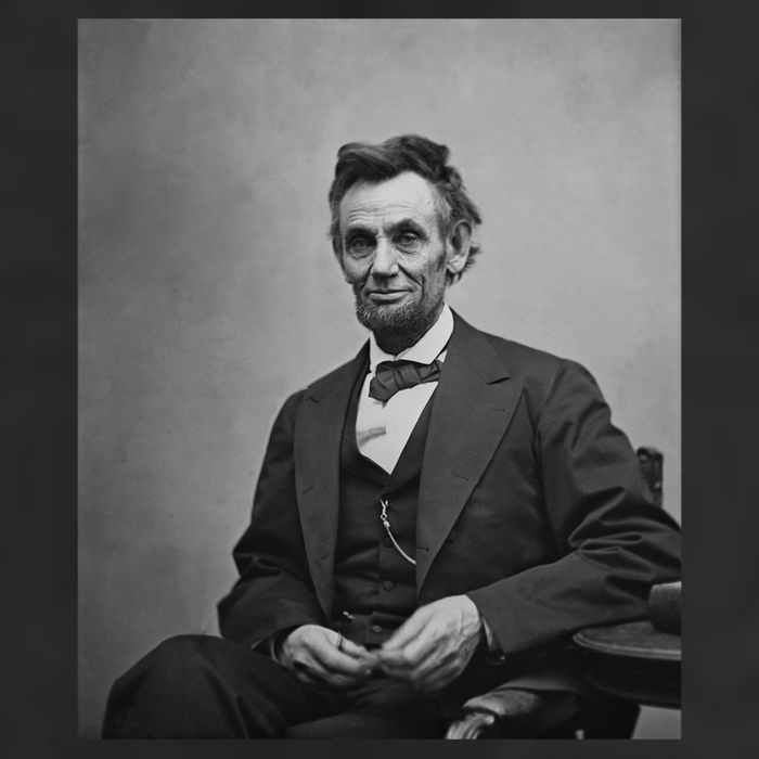 Abraham Lincoln Seated And Holding His Spectacles And A Pencil On Feb 1865 7 Panel Mesh Trucker Snapback Hat