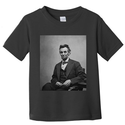 Abraham Lincoln Seated And Holding His Spectacles And A Pencil On Feb 1865 Toddler T-Shirt