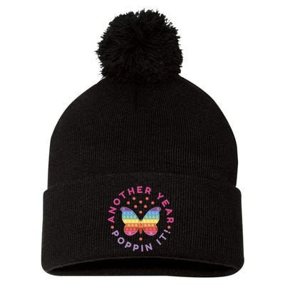 Another Year Poppin It Butterfly Push Pop Pom Pom 12in Knit Beanie