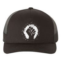 Black History Protest Fist Paint Splatter Yupoong Adult 5-Panel Trucker Hat