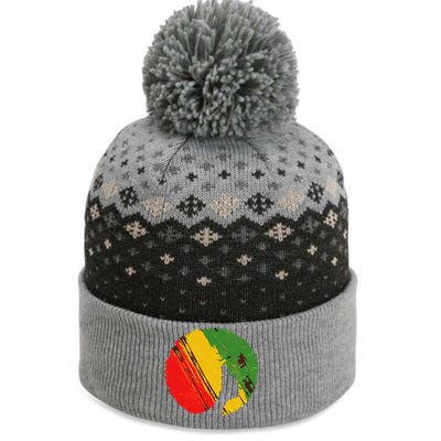 Black Woman with African Colors Afro Hairstyle The Baniff Cuffed Pom Beanie