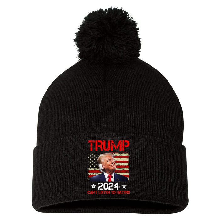 CanT Listen To Haters Trump 2024 Ear Bandage Flag Pom Pom 12in Knit Beanie