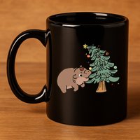 Funny Moo Deng Biting Xmas Tree Baby Pygmy Hippo Christmas 11oz C Handle Ceramic Mug