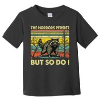 Funny The Horrors Persist But So Do Raccoon Meme Sarcastic Toddler T-Shirt