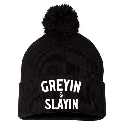 Greyin And Slayin Funny Graying And Slaying Workout Gym Girl Pom Pom 12in Knit Beanie