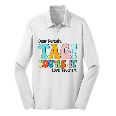 Groovy Dear Parents Tag Youre It Last Day Of School Teacher Silk Touch Performance Long Sleeve Polo