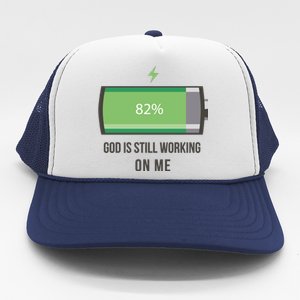 God Is Still Working On Me Battery Loading Trucker Hat