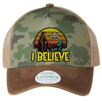 I Believe Funny Alien And Bigfoot Design Distressed Legacy Tie Dye Trucker Hat