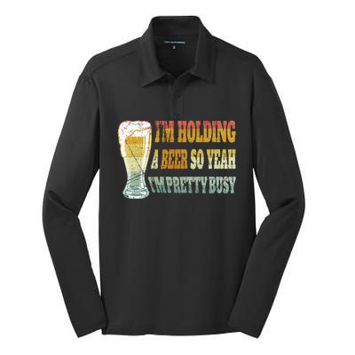 I'm Holding A Beer Of Yeah I'm Pretty Busy Gift For Beer Day Silk Touch Performance Long Sleeve Polo