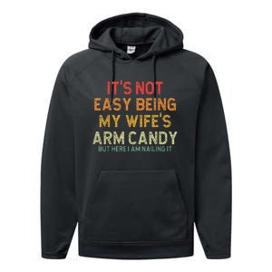 It's Not Easy Being My Wife's Arm Candy But Here I Am Nailin Performance Fleece Hoodie