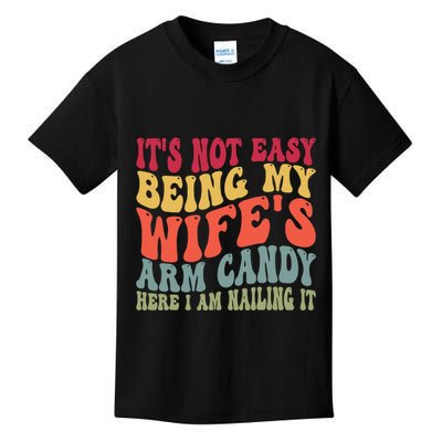 Its Not Easy Being My Wifes Arm Candy Here I Am Nailing It Kids T-Shirt