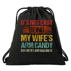 Its Not Easy Being My Wifes Arm Candy But Here I Am Nailin Drawstring Bag