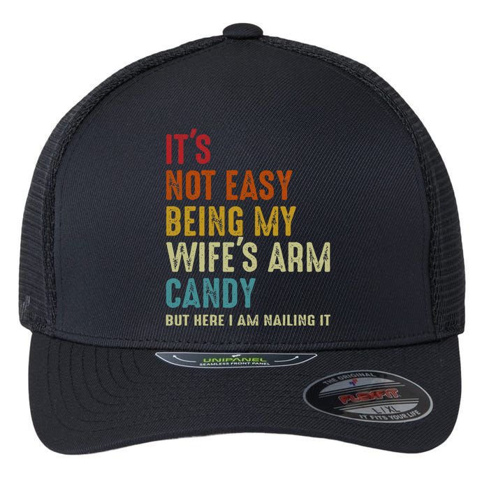 Its Not Easy Being My Wifes Arm Candy But Here I Am Nailin Flexfit Unipanel Trucker Cap