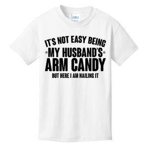 It's Not Easy Being My Husband's Arm Candy But Here I Am Nailing It Kids T-Shirt