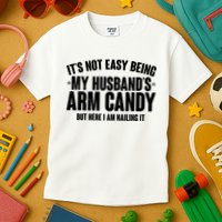 It's Not Easy Being My Husband's Arm Candy But Here I Am Nailing It Kids T-Shirt