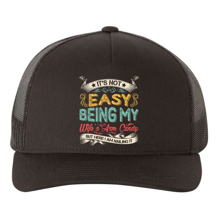 It's Not Easy Being My Wife's Arm Candy But Here I Am Nailin Yupoong Adult 5-Panel Trucker Hat