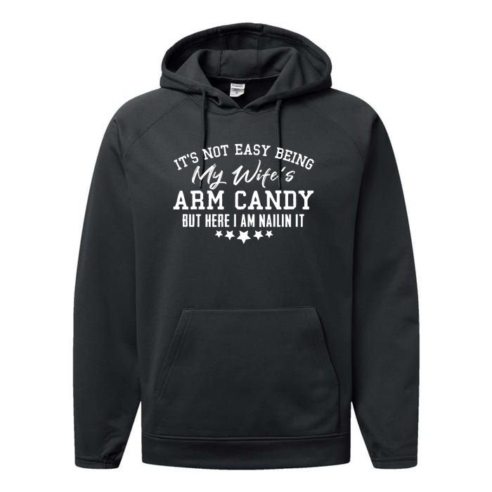 Its Not Easy Being My Wifes Arm Candy But Here I Am Nailin It Performance Fleece Hoodie