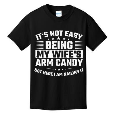 Its Not Easy Being My Wifes Arm Candy Here I Am Nailing It Kids T-Shirt