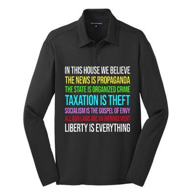 In This House We Believe The News Is Propaganda Silk Touch Performance Long Sleeve Polo