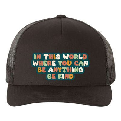 In This World Where You Can Be Anything Be Kind Yupoong Adult 5-Panel Trucker Hat