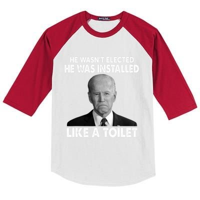 Joe Biden Wasn't Elected He Was Installed Like A Toilet Kids Colorblock Raglan Jersey