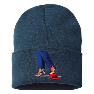 Kamala Harris With High Heels Stepping On Red Hat Sustainable Knit Beanie