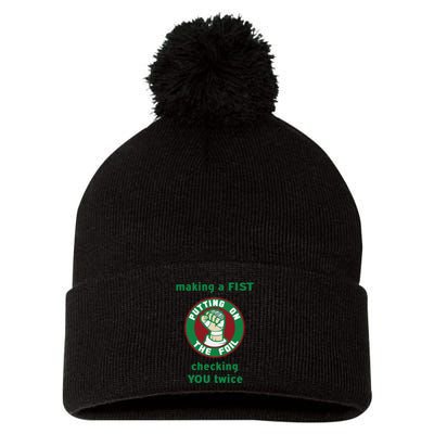 Making A Fist Putting On The Foil Checking You Twice Pom Pom 12in Knit Beanie