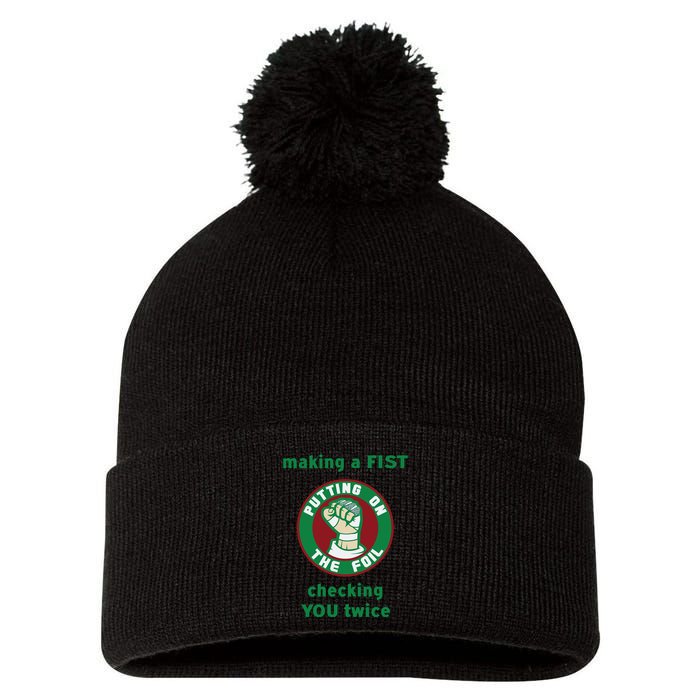 Making A Fist Putting On The Foil Checking You Twice Pom Pom 12in Knit Beanie