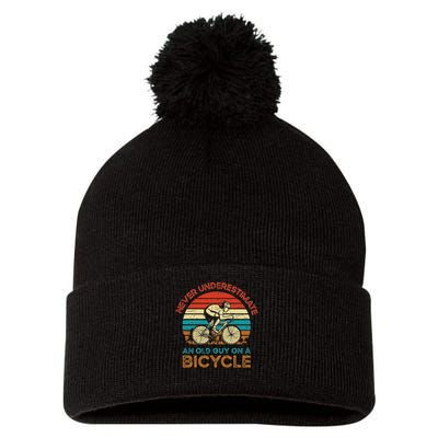 Never Underestimate An Old Guy On A Bicycle Cycling Pom Pom 12in Knit Beanie