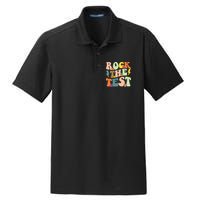 Rock The Test Groovy Design Funny Testing Day Teacher Dry Zone Grid Polo