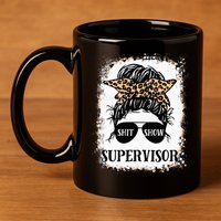 Shit Show Supervisor Women Casual Messy Bun Bleached 11oz C Handle Ceramic Mug