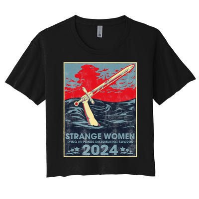 Strange Women Lying In Ponds Distributing Swords 2024 Women's Crop Top Tee