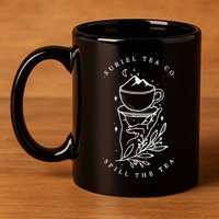 The SurielS Tea Co Spill The Tea 11oz C Handle Ceramic Mug